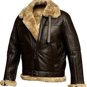 May include: A brown leather bomber jacket with a shearling collar and lining. The jacket has a zipper closure, two front pockets, and a belt at the waist.