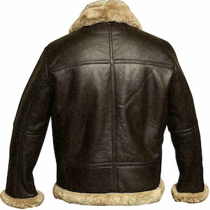 May include: A brown leather bomber jacket with a shearling collar and lining. The jacket has a zipper closure and two pockets.