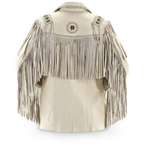 May include: A cream-colored leather jacket with fringe detailing around the neckline and sleeves. The jacket has a decorative embroidered design on the back.
