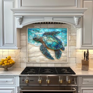 May include: A decorative kitchen backsplash featuring a mosaic-style sea turtle in shades of blue and green. The artwork depicts the turtle on a sandy beach with ocean waves. The backsplash is installed above a stainless steel gas range.
