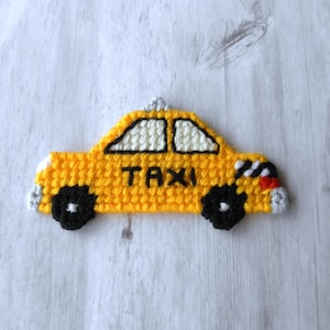 May include: Yellow crocheted taxi cab with black wheels and the word "TAXI" on the side.