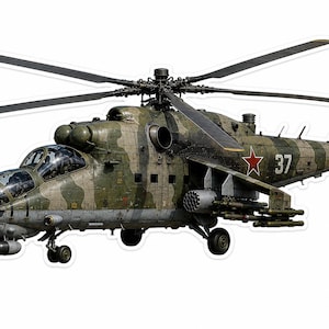 Könnte beinhalten: Ein militärischer Kampfhubschrauber mit grün-braunem Tarnmuster. Das Fluggerät zeigt ein rotes Sternemblem und die Nummer 37 an der Seite. Es ist mit einer am Bug montierten Kanone, seitlichen Raketenwerfern und Rotoren ausgestattet.