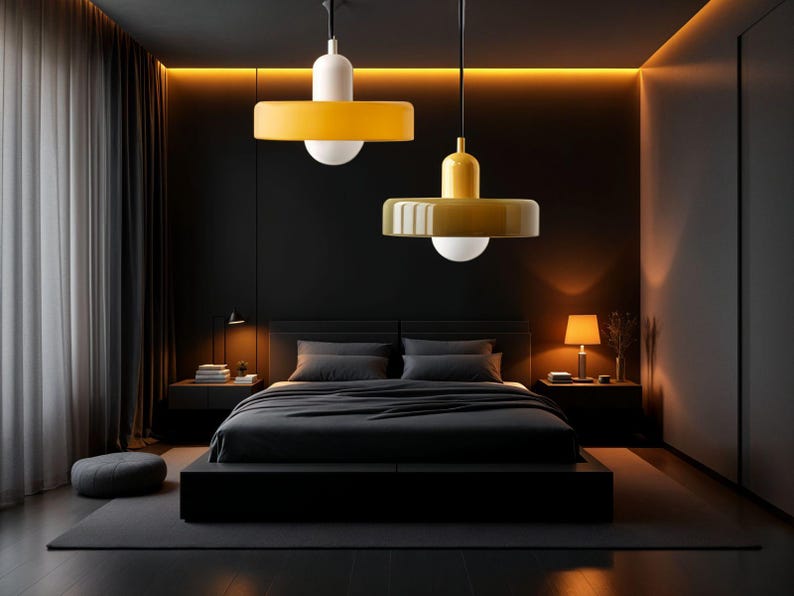 May include: Two modern yellow pendant lights with white shades hang over a black bed in a dark bedroom with a gray rug.