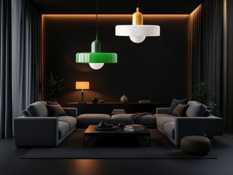May include: A dark living room with a gray sectional sofa, a black coffee table, and two pendant lights. One light has a green shade and the other has a white shade.
