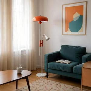 May include: A modern living room scene featuring a teal sofa, a wooden coffee table, and a retro orange and white floor lamp. A framed abstract art piece hangs on the wall. A cup of coffee sits on the table.