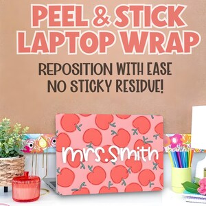 May include: A pink laptop wrap with a pattern of red apples and the name "Mrs. Smith" in white. The background features text that reads "Peel & Stick Laptop Wrap" and "Reposition with Ease, No Sticky Residue!"