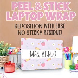 May include: A laptop wrap with a light purple background featuring apples, pencils, and stars. The wrap has a white band with "MRS. ATENCIO" printed on it. The background reads "PEEL & STICK LAPTOP WRAP" and "REPOSITION WITH EASE NO STICKY RESIDUE!"