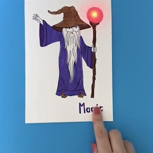 May include: A hand-drawn illustration of a wizard with a long white beard, wearing a purple robe and a brown pointed hat. The wizard is holding a staff with a glowing red orb at the top. The word "Magic" is written below the wizard.