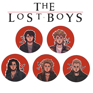 May include: Six round red buttons with white borders featuring illustrations of four characters from the movie "The Lost Boys". Each button has a black bat silhouette in the background.