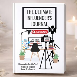 May include: A white journal with the title "THE ULTIMATE INFLUENCER'S JOURNAL" and illustrations of a camera, computer, and desk. The cover also features the text "SUBSCRIBE" and "LIVE YOUR BEST STORY."