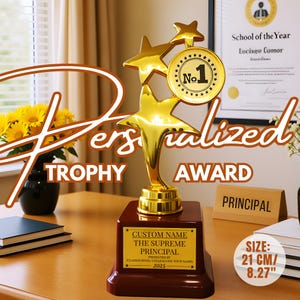 May include: A gold-colored trophy with star accents and a "No. 1" medallion. The trophy sits on a dark red base with a customizable plaque. The text "Personalized Trophy Award" is visible. The size is 8.27 inches.
