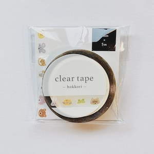 May include: A roll of clear tape in a plastic package. The tape has a dark brown wooden-like edge. The packaging includes the text "clear tape - hokkori -" and a strip of animal illustrations. The tape is 7mm x 5m.