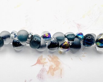 Nautical Mix Unicorne Beads, Boro Teardrops, 25 Beads Per Strand, Mixture of Original, Tumbled and Metallic Teardrops In Varying Deep Blue