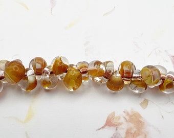 Honey, Unicorne Boro Teardrop Beads With Inside Molten Honey Colors And Clear Boro Glass, 25 Beads Per Strand