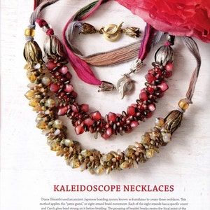 May include: Two necklaces featuring braided silk ribbons and clusters of beads. One necklace has amber and gold-toned beads with brass-colored metal end caps. The other has red and pink beads with silver-colored metal end caps and leaf-shaped toggles.