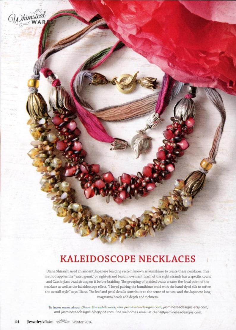 May include: Two necklaces featuring braided silk ribbons and clusters of beads. One necklace has amber and gold-toned beads with brass-colored metal end caps. The other has red and pink beads with silver-colored metal end caps and leaf-shaped toggles.