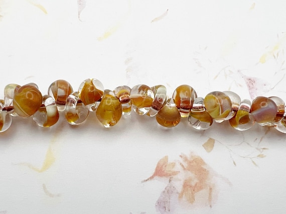 Honey, Unicorne Boro Teardrop Beads With Inside Molten Honey Colors And Clear Boro Glass, 25 Beads Per Strand