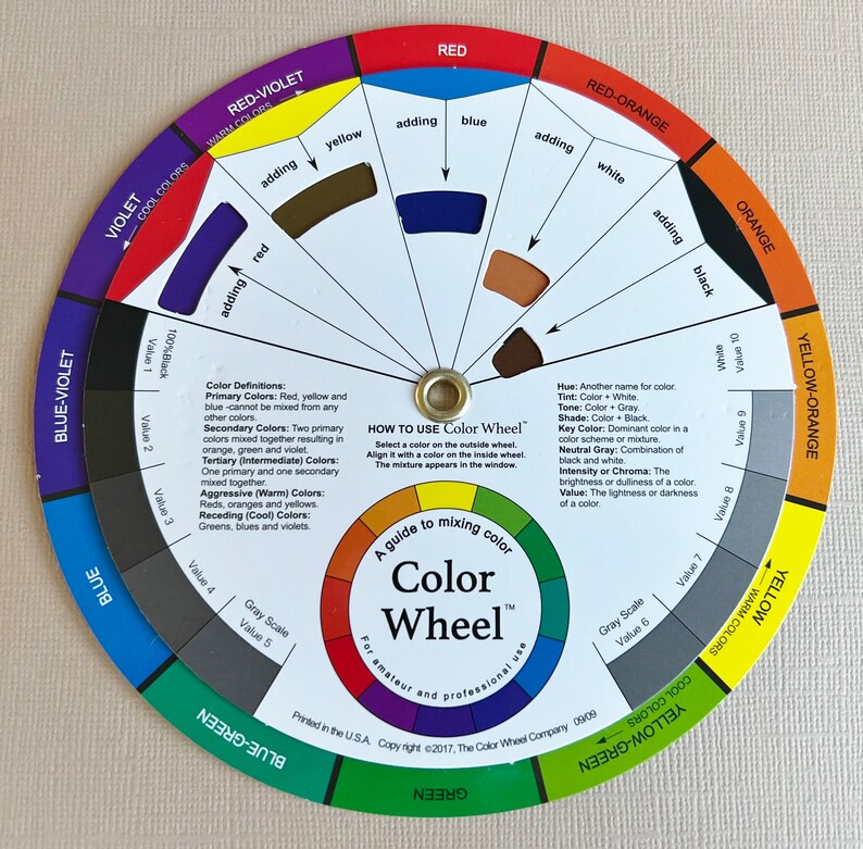 May include: A color wheel with a circular chart showing primary, secondary, and tertiary colors. The wheel is divided into 12 sections, each representing a different color. The colors are labeled with their names and values. The wheel is designed for mixing colors and includes instructions on how to use it.