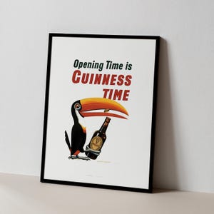 May include: Framed print with a toucan and a Guinness bottle. The text reads "Opening Time is Guinness Time". The toucan has a large orange beak and is set against a white background. The artwork has a vintage style.