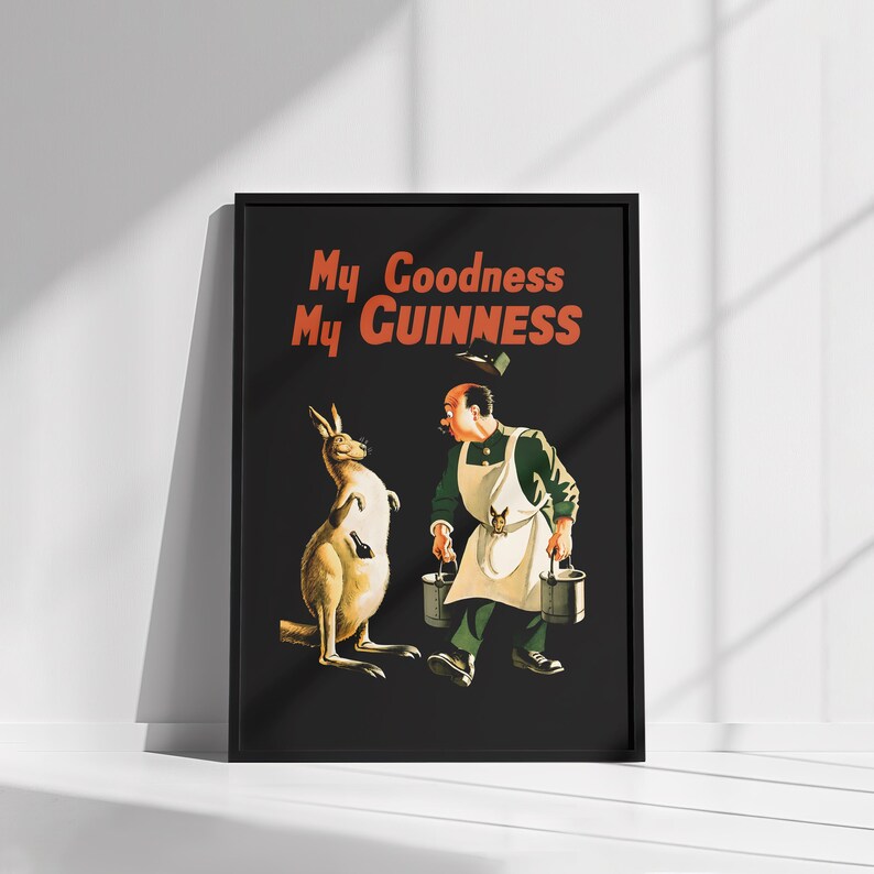 K&ouml;nnte beinhalten: Gerahmte Vintage-Werbung f&uuml;r Guinness. Das Kunstwerk zeigt ein K&auml;nguru mit einer Flasche und einen Mann mit Eimern, mit dem Text "My Goodness My Guinness" in Rot und Wei&szlig;.