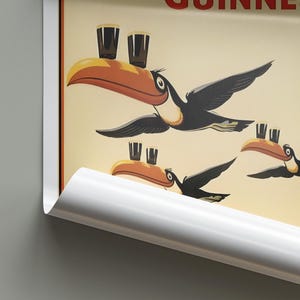 May include: A vintage-style poster featuring a toucan carrying a glass of Guinness beer. The toucan is flying with its wings spread out. The poster has a yellow background with the text "Guinness" in red letters.