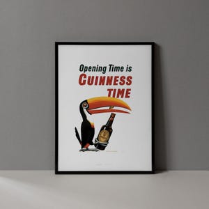 May include: Framed print with a toucan and a Guinness bottle. The toucan has a large orange and yellow beak. The text "Opening Time is Guinness Time" is displayed in red and green.