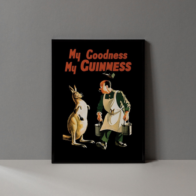 May include: Black framed print featuring a vintage advertisement. The image shows a kangaroo holding a bottle and a man carrying buckets, with the text "My Goodness My Guinness" in red and orange.