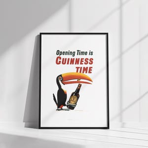May include: Framed print with a toucan and a Guinness bottle. The text "Opening Time is Guinness Time" is displayed in red and black font. The toucan has a large orange beak. The artwork is set against a white background.