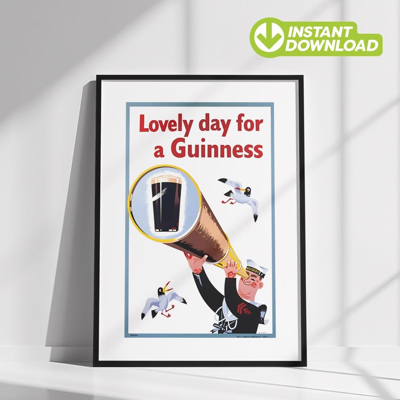 May include: A framed vintage-style poster with the text "Lovely day for a Guinness." The illustration depicts a sailor looking through a telescope at a pint of Guinness, with seagulls in the background. The poster has a white background and a black frame.