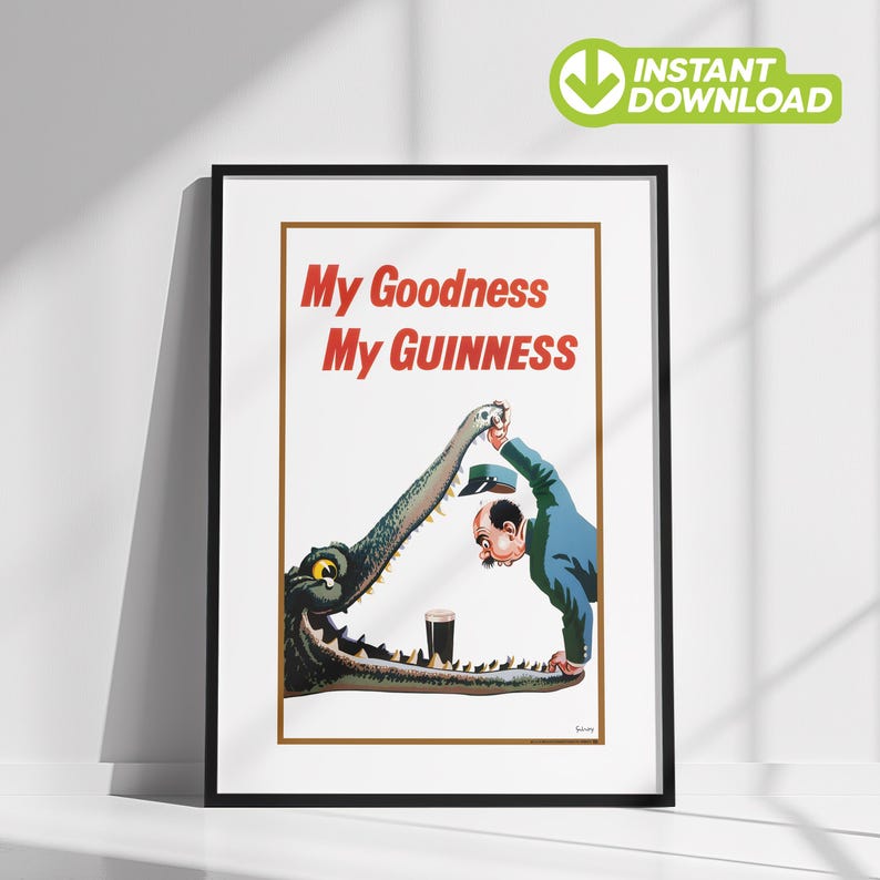 Op de afbeelding: Ingelijste vintage Guinness-poster met een cartoonillustratie. Een man in een blauw pak biedt een hoed aan een krokodil, die een pint Guinness in zijn bek heeft. De tekst "My Goodness My Guinness" is rood.
