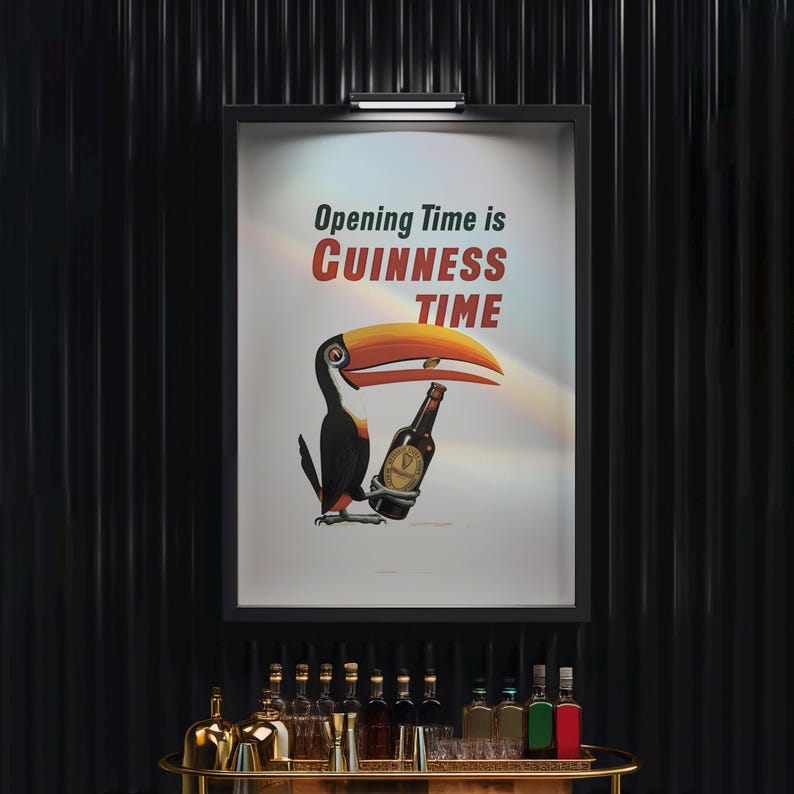 May include: A framed poster with the text "Opening Time is Guinness Time" features a toucan holding a Guinness bottle. The toucan has a large orange and yellow beak, black feathers, and is set against a white background.
