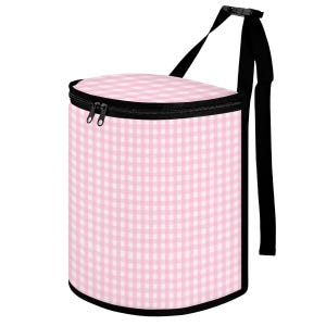 May include: A cylindrical cooler bag with a pink and white gingham pattern. The bag has a black zipper, trim, and adjustable shoulder strap. The bag is designed to keep items cold.