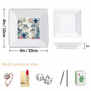 May include: White square ceramic dish, 4 inches (10 cm) wide, with a gold rim. The center features a colorful Asian-inspired landscape design. The image also shows the dish's side profile and examples of its multi-purpose use.