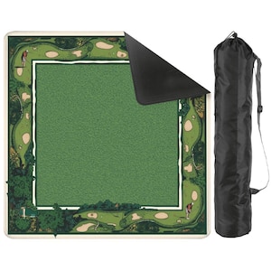 May include: A green golf practice mat with a detailed course design, featuring golfers and sand traps. The mat has a central green area and a surrounding border with a golf course illustration. A black carrying bag with a shoulder strap is included.