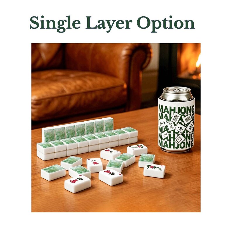 May include: A set of white mahjong tiles with green marbled backs and red or black character designs, arranged in a single layer. A white beverage can cooler with green text reading MAHJONG and small tile illustrations sits next to the tiles.