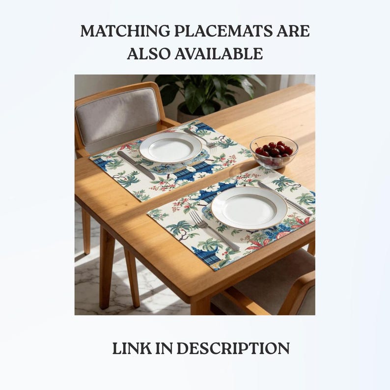 May include: Two rectangular placemats featuring a blue and green botanical and pagoda print on a cream background. Each placemat is set with a white plate, a silver fork, and a silver knife. The text MATCHING PLACEMATS ARE ALSO AVAILABLE is visible.