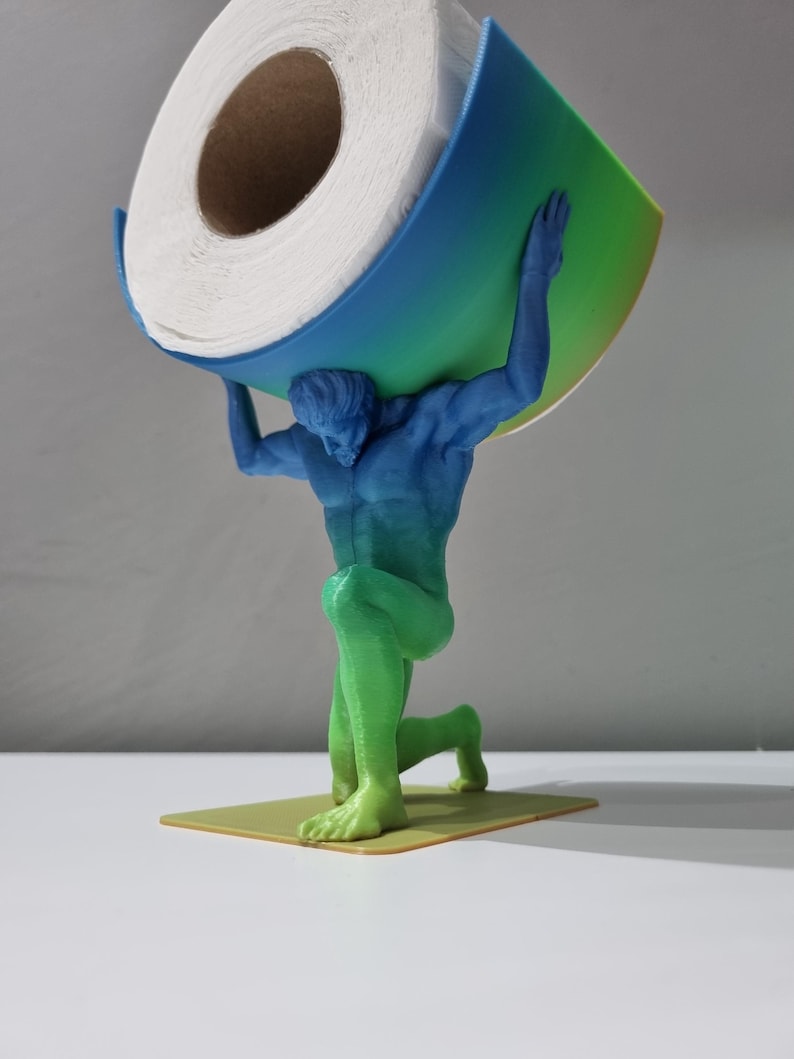 May include: A 3D printed toilet paper holder in the shape of a person holding a roll of toilet paper. The holder is painted in a gradient of blue, green, and yellow.
