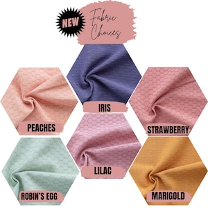 May include: A collection of six fabric swatches arranged in a hexagonal pattern, each featuring a textured circular grid design. The colors are labeled as Peaches, Iris, Strawberry, Robin's Egg, Lilac, and Marigold. The text reads NEW Fabric Choices.