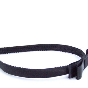 May include: A black headband with a black satin bow.
