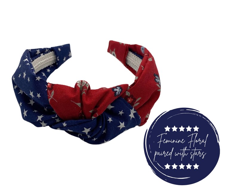 May include: A red and blue headband with a floral pattern and white stars. The headband is knotted in the center and has a white elastic band.