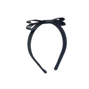 May include: A black satin headband with a large black bow.