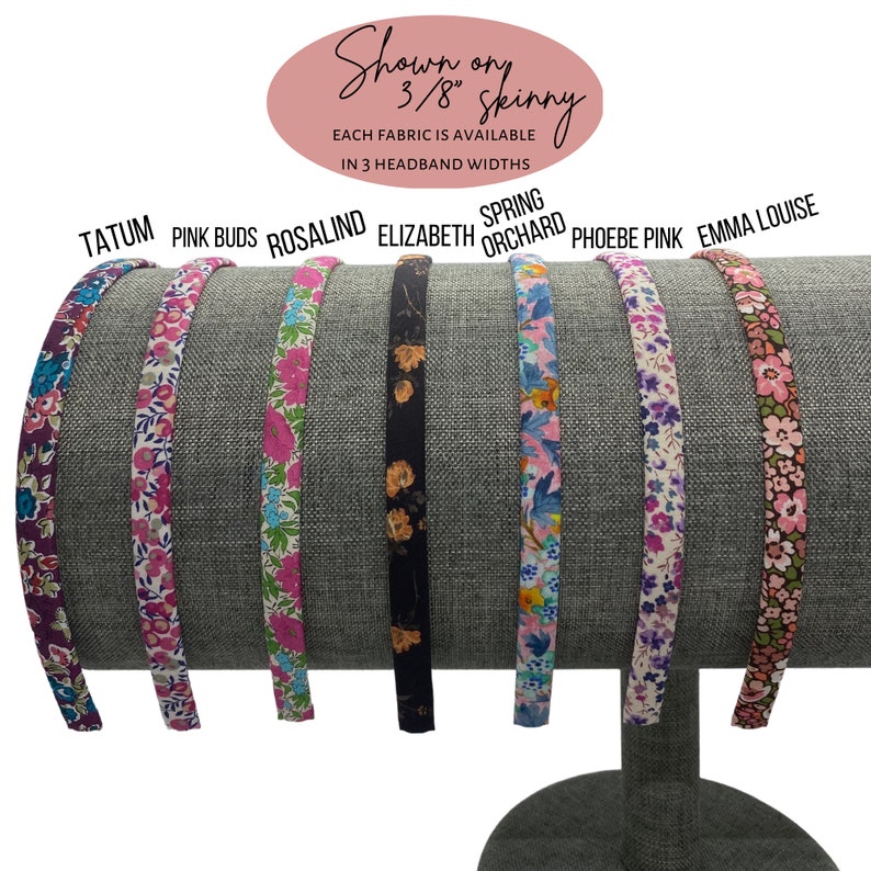 May include: A display of seven fabric headbands in various floral patterns. The headbands are shown on a gray stand. The text on the image says "Shown on 3/8" skinny" and lists the fabric names: Tatum, Pink Buds, Rosalind, Elizabeth, Spring Orchard, Phoebe Pink, and Emma Louise.