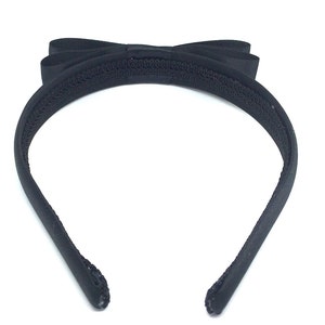 May include: Black headband with a large black satin bow. The headband is made of a soft, stretchy material.