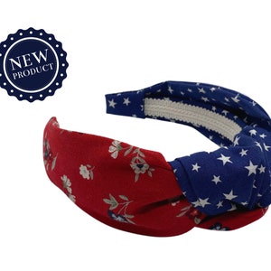 May include: A red and blue knotted headband with a floral pattern on one side and a white star pattern on the other side.