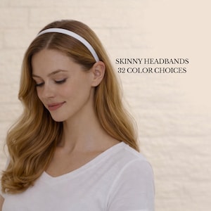 May include: A woman wearing a white v-neck shirt and a thin white headband. The image includes the text "SKINNY HEADBANDS 32 COLOR CHOICES". The headband is a simple, elegant accessory.