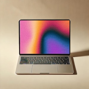 May include: A silver laptop computer with a black keyboard and a colorful gradient background on the screen.