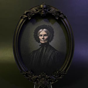 May include: An oval portrait of an older woman in a black dress and a white lace cap. The portrait is framed in a black ornate frame with a skull at the top.