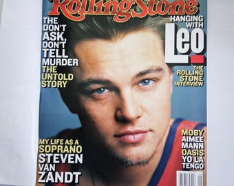 May include: Rolling Stone magazine cover featuring Leonardo DiCaprio with blue eyes. The cover includes the text "THE DON'T ASK, DON'T TELL MURDER THE UNTOLD STORY" and "HANGING WITH Leo". Additional text includes "THE ROLLING STONE INTERVIEW".