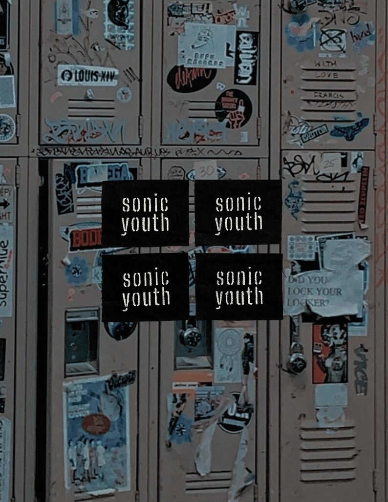 May include: A collage of vintage lockers covered in stickers and graffiti. Four black squares with the band name "sonic youth" in white text are centered. The lockers are a muted brown color.