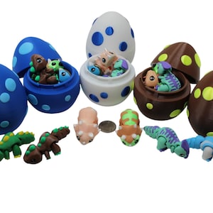 3D Printed Dinosaur egg Pack – triceratops, T-rex, and Parasaur.  All three come packed in a Dino egg. Great for All Ages even adults.